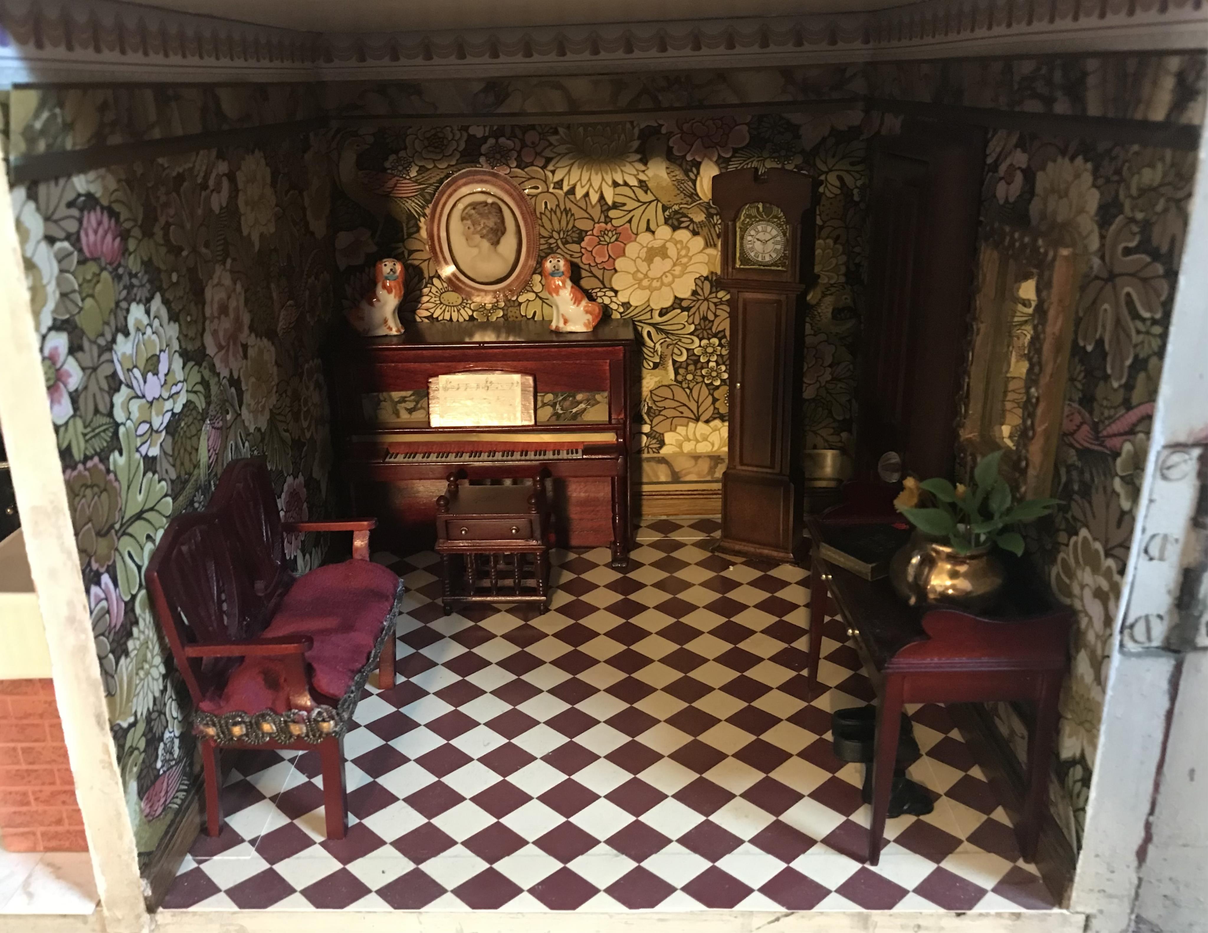 A late 19th century doll's house, with a single front opening panel, incorporating eight internal rooms, flat roof with parapet, dimensions 81.5cm high, 79cm wide, 30cm deep, together with modern manufactured furniture a